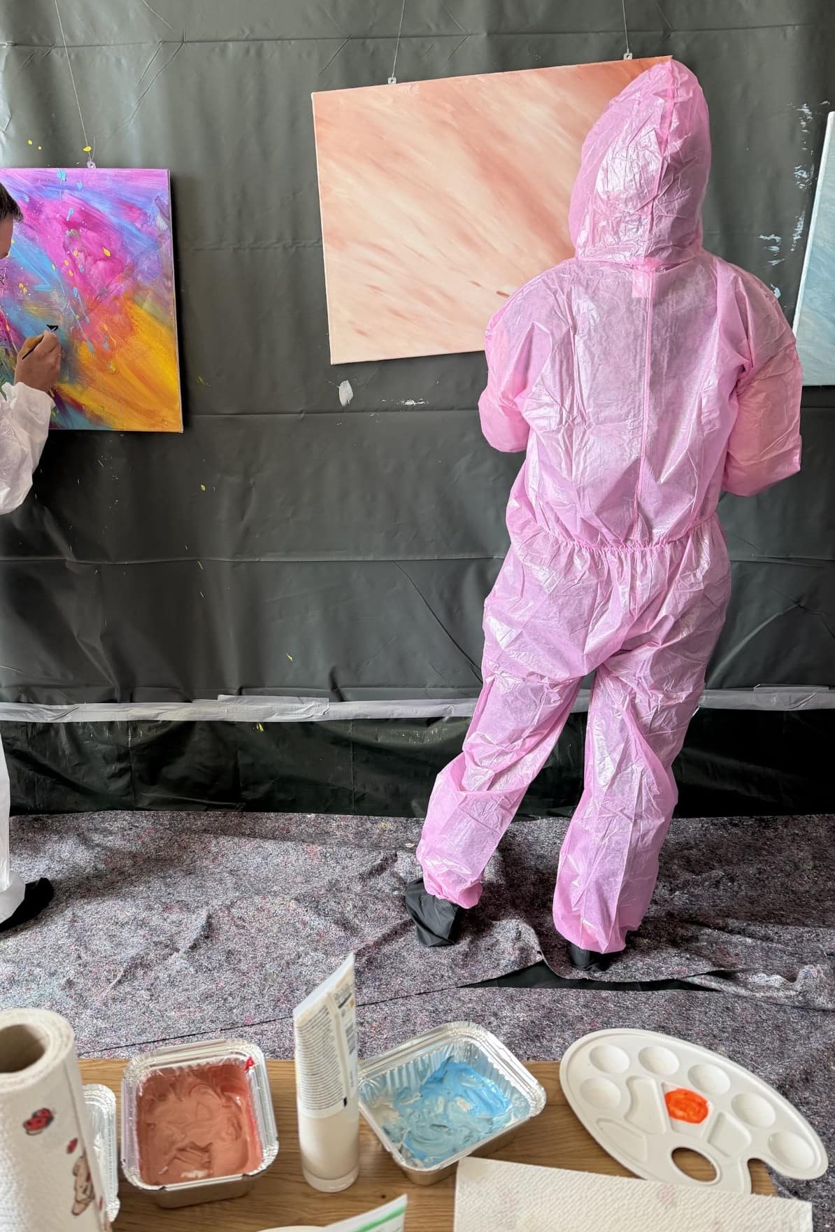 Person im Schutzanzug beim Action Painting